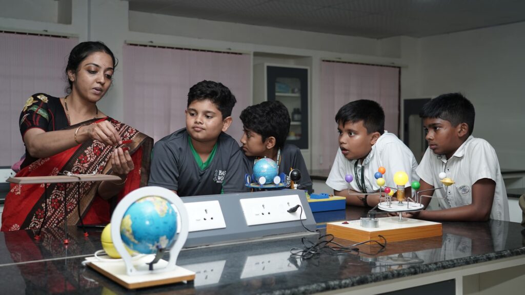 School children learning basic robotics, coding, and engineering concepts through practical classroom projects