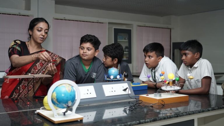 School children learning basic robotics, coding, and engineering concepts through practical classroom projects